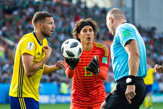 Marcus Berg of Sweden and goalkeeper Guillermo Ochoa  of