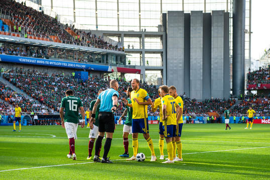Referee Nestor Pitana and Andreas Granqvist of Sweden