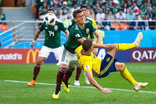 Rafael Marquez  of Mexico and Marcus Berg of Sweden