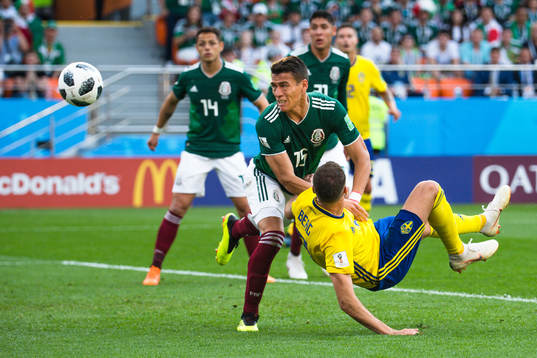Rafael Marquez  of Mexico and Marcus Berg of Sweden