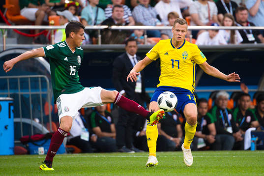 Hector Moreno of Mexico and Viktor Claesson of Sweden