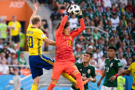 Ola Toivonen of Sweden against goalkeeper Guillermo Ochoa