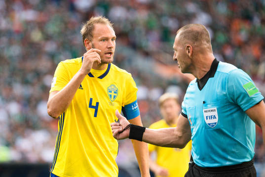 Andreas Granqvist of Sweden and Referee Nestor Pitana