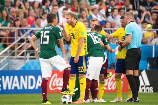 Hector Moreno of Mexico and Ola Toivonen of Sweden