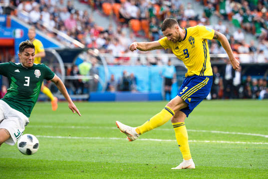Carlos Salcedo of Mexico and Marcus Berg of Sweden