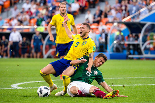Marcus Berg of Sweden against Hector Moreno of Mexico