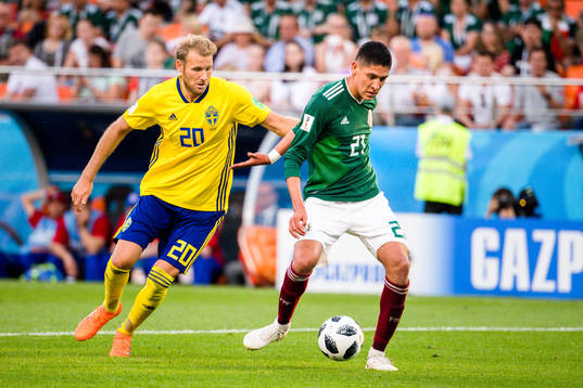 Ola Toivonen of Sweden and Edson Alvarez of Mexico