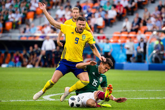 Marcus Berg of Sweden and Hector Moreno of Mexico