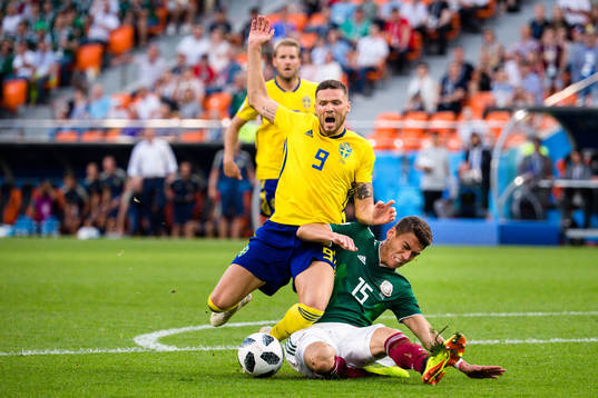 Marcus Berg of Sweden and Hector Moreno of Mexico