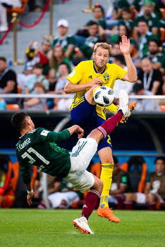 Ola Toivonen of Sweden and Edson Alvarez  of Mexico