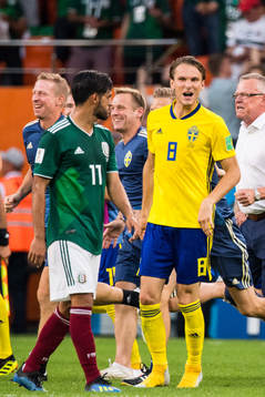 Albin Ekdal of Sweden heckle Carlos Vela of Mexico