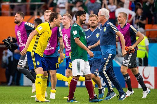 Albin Ekdal of Sweden heckle Carlos Vela of Mexico