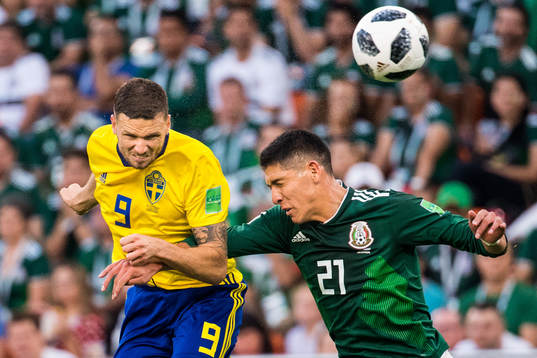 Marcus Berg of Sweden and Edson Alvarez of Mexico