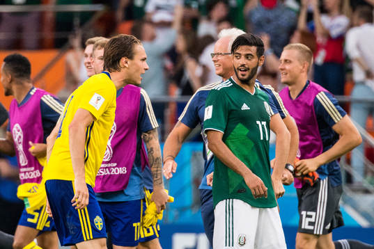 Albin Ekdal of Sweden heckle Carlos Vela of Mexico