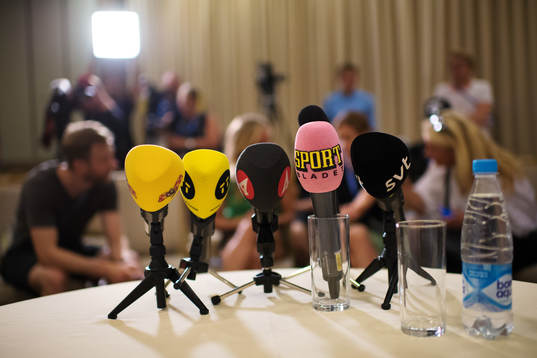 TV microphones in front of the seat of head coach Janne
