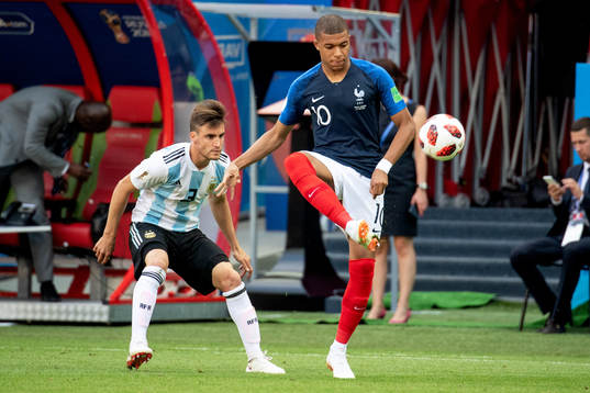 Nicolas Tagliafico of Argentina and Kylian Mbappe of France