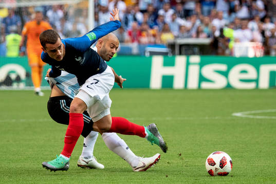 Antoine Griezmann of France and Javier Mascherano of