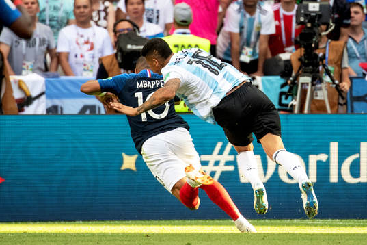 Kylian Mbappe of France is brought down by Marcos Rojo of