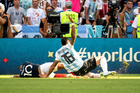 Kylian Mbappe of France is brought down by Marcos Rojo of