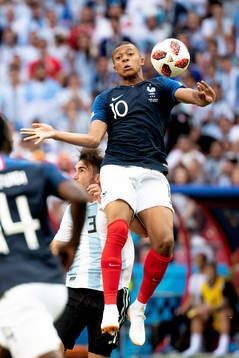 Kylian Mbappe of France and Nicolas Tagliafico of Argentina