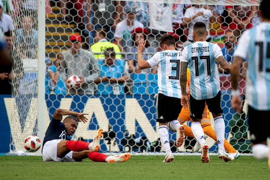 Kylian Mbappe of France goes down