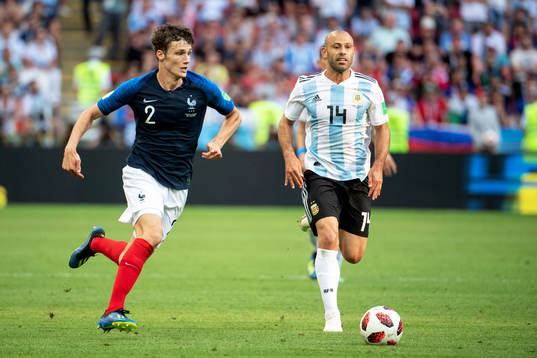 Benjamin Pavard of France and Javier Mascherano of Argentina