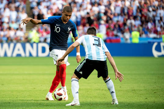 Kylian Mbappe of France and Nicolas Tagliafico of Argentina