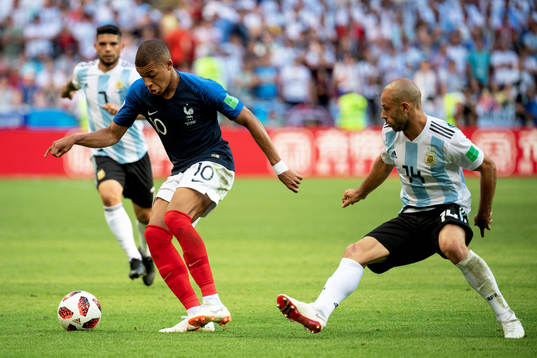 Kylian Mbappe of France and Javier Mascherano of Argentina