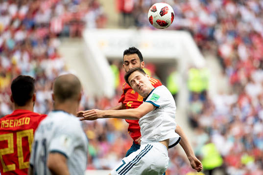 Sergio Busquets of Spain and Daler Kuziaev of Russia