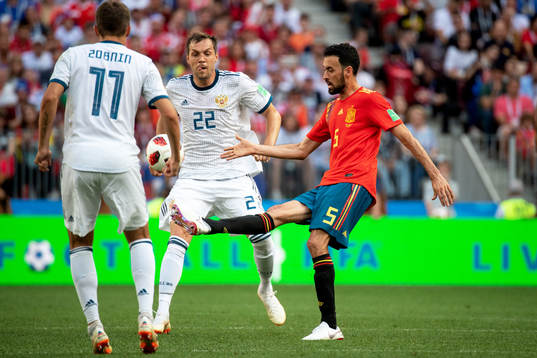 Sergio Busquets of Spain and Artem Dzyuba of Russia