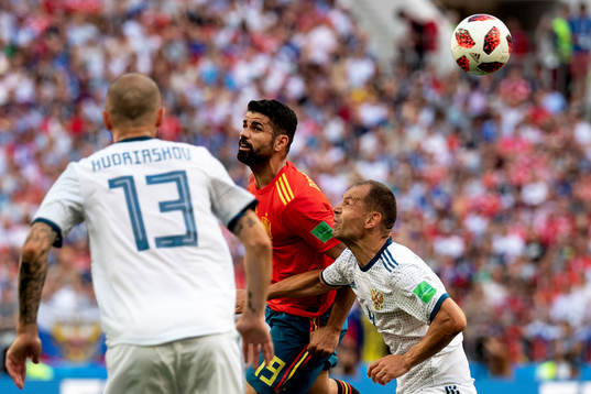 Diego Costa of Spain and Sergey Ignashevich of Russia