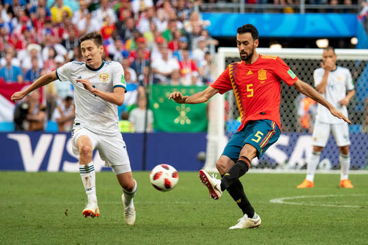 Daler Kuziaev of Russia and Sergio Busquets of Spain