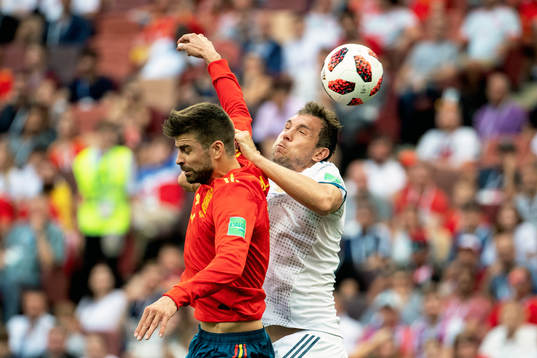 Gerard Pique of Spain and Artem Dzyuba of Russia