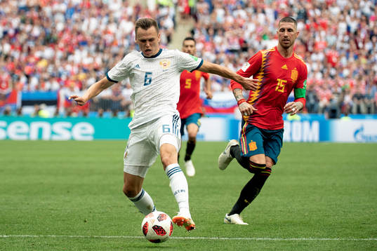 Denis Cheryshev of Russia and Sergio Ramos of Spain