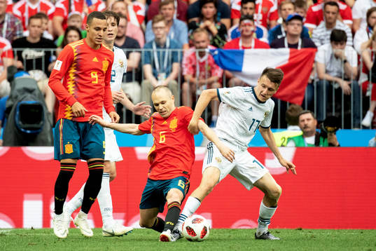 Andres Iniesta of Spain and Aleksandr Golovin of Russia