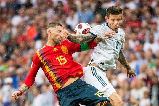 Sergio Ramos of Spain in action with Fedor Smolov of Russia
