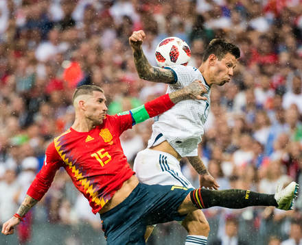 Sergio Ramos of Spain in action with Fedor Smolov of Russia