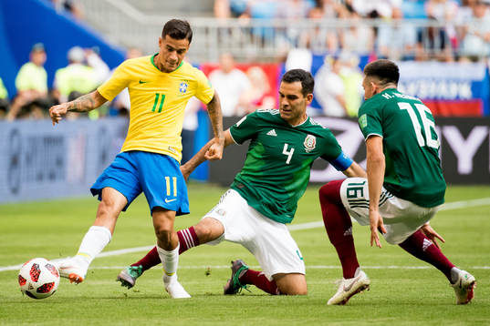 Philippe Coutinho of Brazil and Rafael Marquez of Mexico