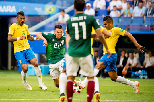 Paulinho of Brazil and Hirving Lozano of Mexico