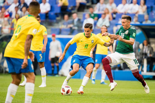 Philippe Coutinho of Brazil and Hector Herrera of Mexico