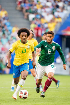 Willian of Brazil and Jonathan Dos Santos of Mexico