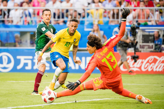 Neymar of Brazil and goalkeeper Guillermo Ochoa of Mexico