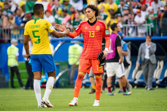 Casemiro of Brazil and goalkeeper Guillermo Ochoa of Mexico