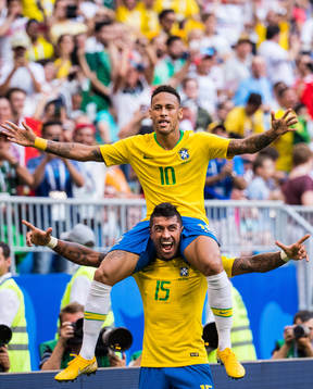 Neymar of Brazil celebrates with Paulinho