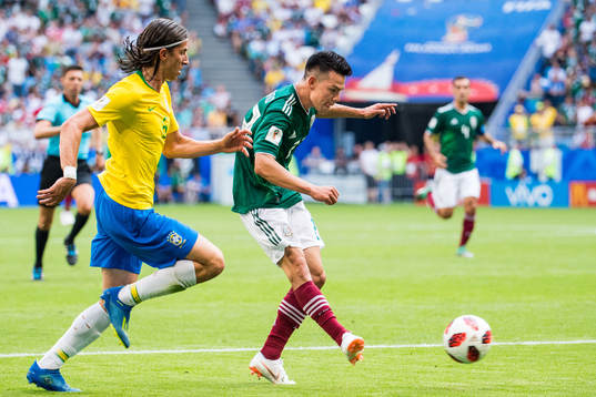 Hirving Lozano of Mexico and Filipe Luis of Brazil