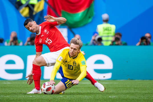 Blerim Dzemaili competes for the ball with Emil Forsberg of