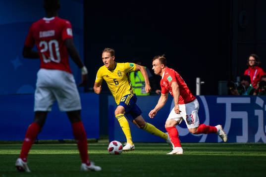 Ludwig Augustinsson of Sweden competes for the ball with
