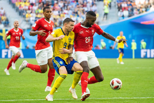 Marcus Berg of Sweden competes for the ball with Johan