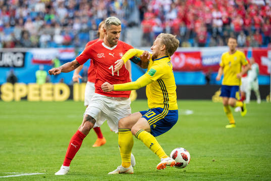 Valon Behrami of Switzerland tackles Emil Forsberg of Sweden