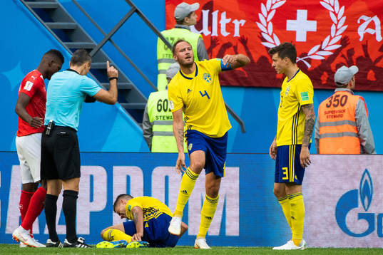 Andreas Granqvist gestures that Mikael Lustig of Sweden is
